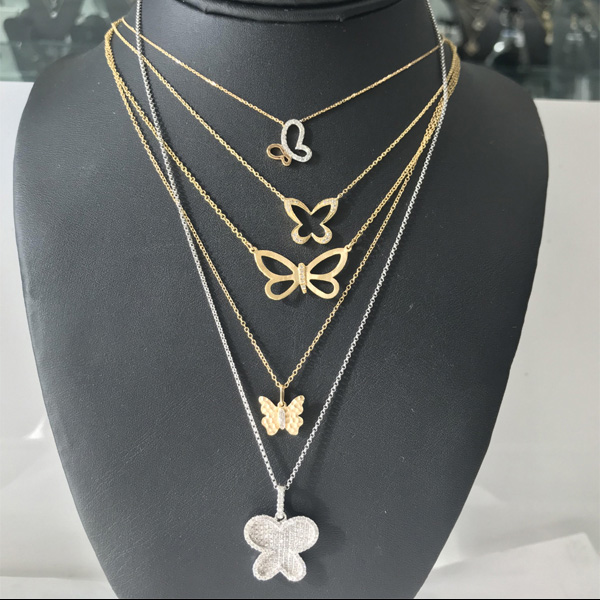 A Collection of 14K white/yellow gold and diamond butterfly pendants and necklaces